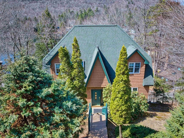 view of front of home featuring a wooded view