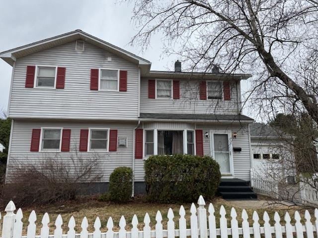 view of front of home with a chimney and a fenced front yard