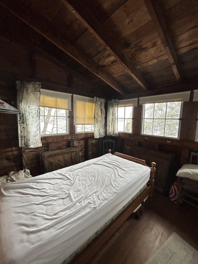bedroom featuring beam ceiling, wooden ceiling, and wood finished floors