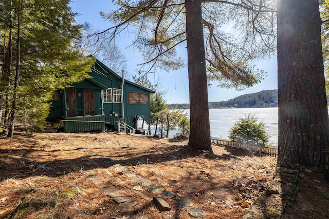 view of property exterior with a water view