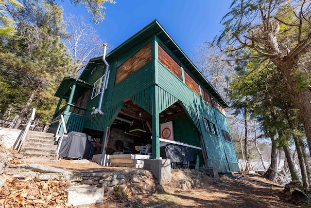 view of side of home featuring stairs