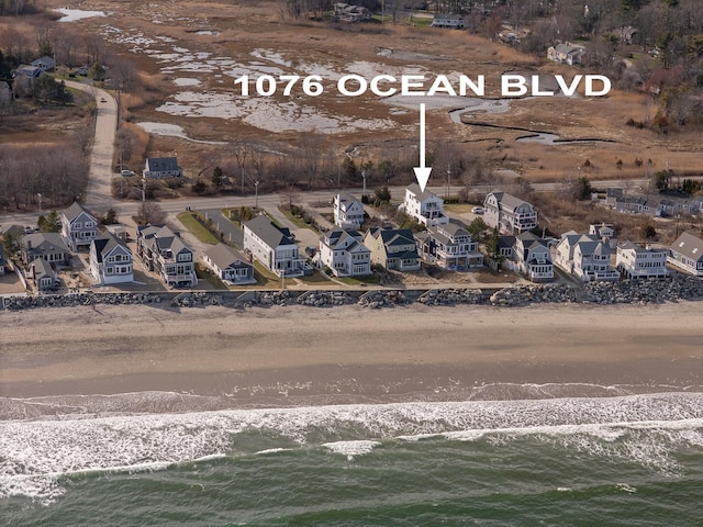 drone / aerial view with a water view and a view of the beach