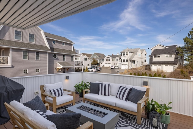 balcony with a residential view, a grill, and an outdoor living space with a fire pit