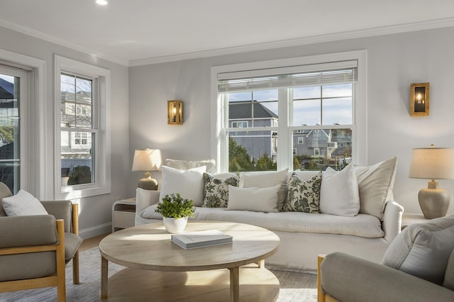 living area featuring light wood-type flooring, baseboards, and ornamental molding