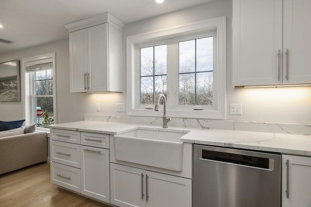 kitchen featuring light stone counters, recessed lighting, white cabinetry, stainless steel dishwasher, and a sink