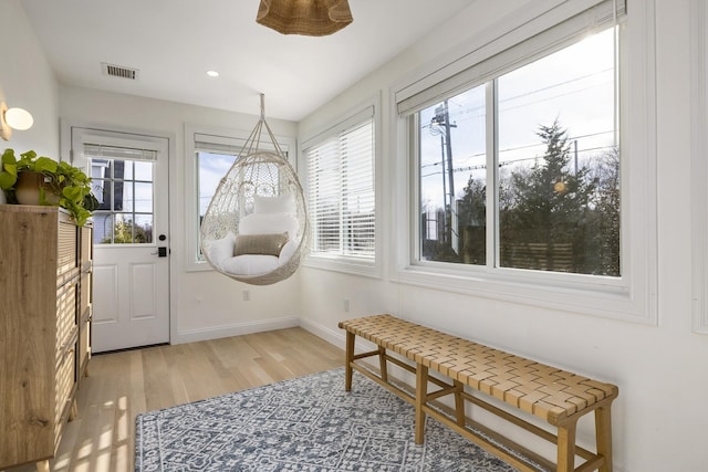 entryway with visible vents, a wealth of natural light, light wood finished floors, and baseboards