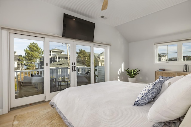bedroom with lofted ceiling, light wood-style flooring, visible vents, access to exterior, and ceiling fan