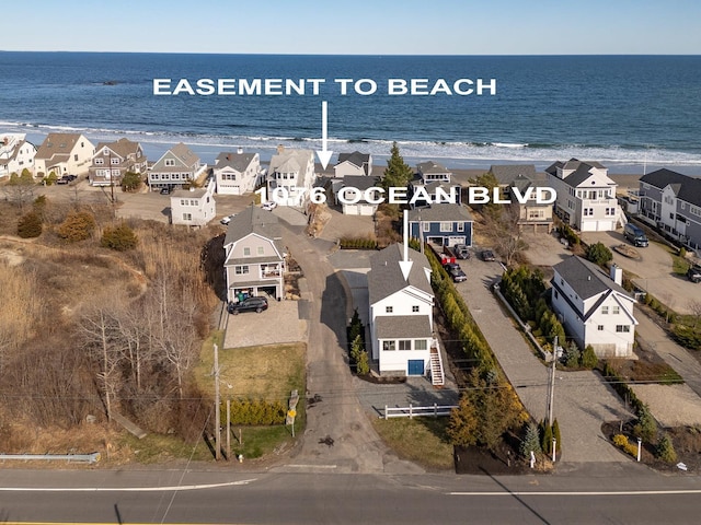 bird's eye view with a water view and a residential view