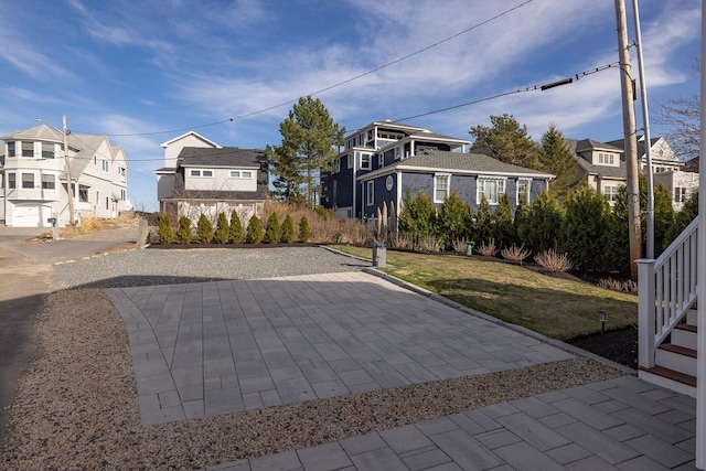 view of sport court featuring a residential view and a lawn
