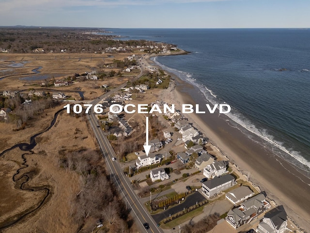 aerial view with a water view and a view of the beach