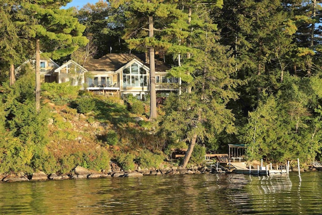 dock area featuring a water view and a wooded view
