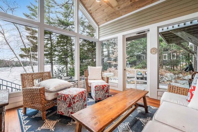 sunroom / solarium featuring a water view