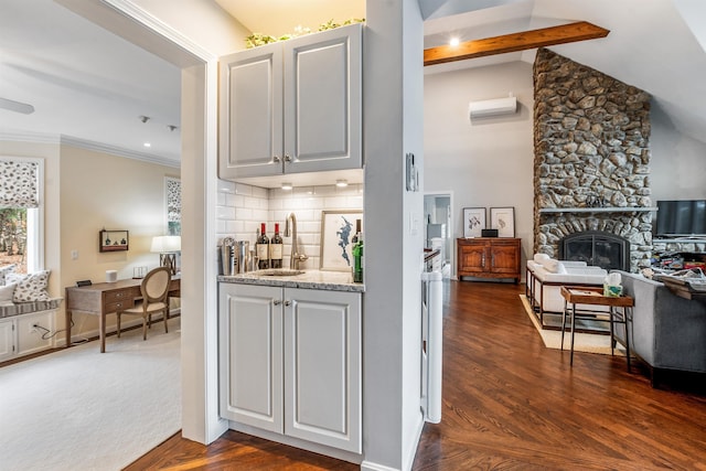 bar with a stone fireplace, ornamental molding, a wall mounted air conditioner, backsplash, and a sink