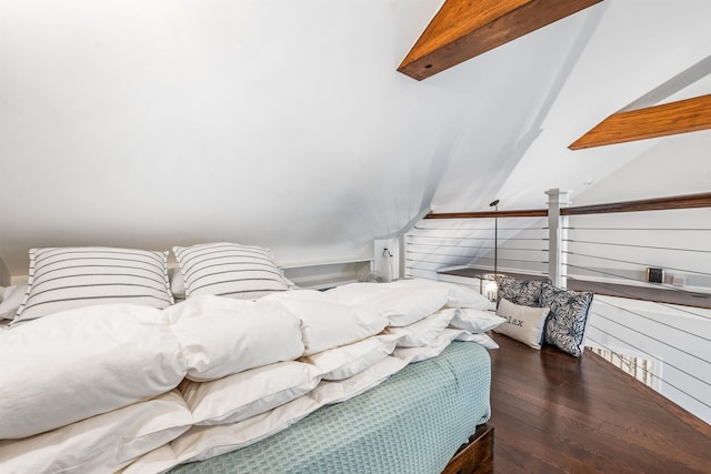 bedroom with wood walls, hardwood / wood-style flooring, and vaulted ceiling