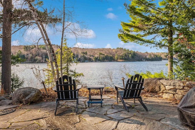 view of patio featuring a water view and a view of trees