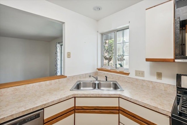 kitchen featuring light countertops, dishwasher, white cabinets, and a sink