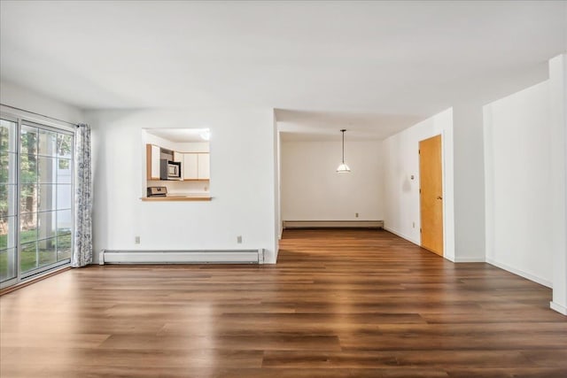 unfurnished living room featuring baseboard heating, baseboards, and wood finished floors