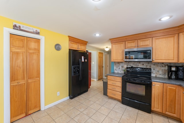 kitchen featuring black appliances, dark countertops, backsplash, light tile patterned floors, and baseboards