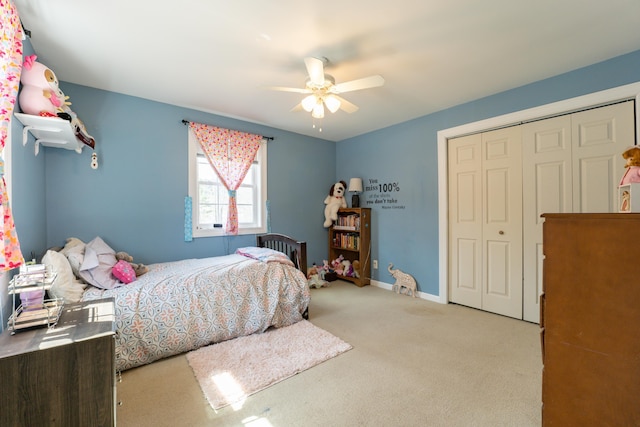 bedroom with carpet flooring, a closet, ceiling fan, and baseboards