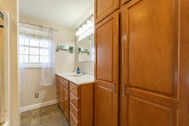 bathroom with vanity and baseboards