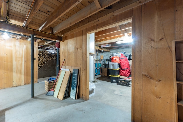 unfinished below grade area featuring water heater