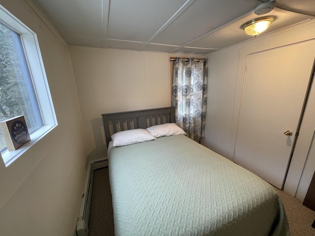 bedroom featuring baseboard heating and a decorative wall