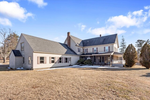 33 Bunker Hill Rd, Auburn, NH 03032 - back of house with a chimney, a yard, a patio area, and a sunroom