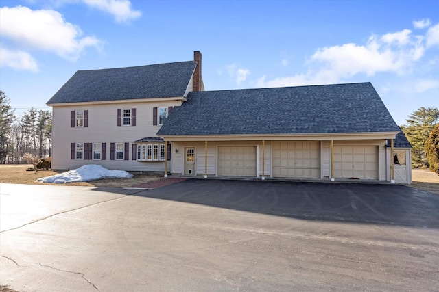 33 Bunker Hill Rd, Auburn, NH 03032 - view of front of property featuring roof with shingles, a chimney, and driveway