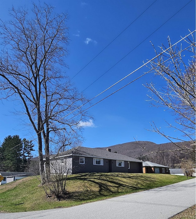 exterior space featuring a yard and a mountain view