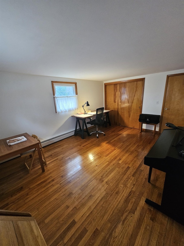 office space with a baseboard radiator and wood finished floors