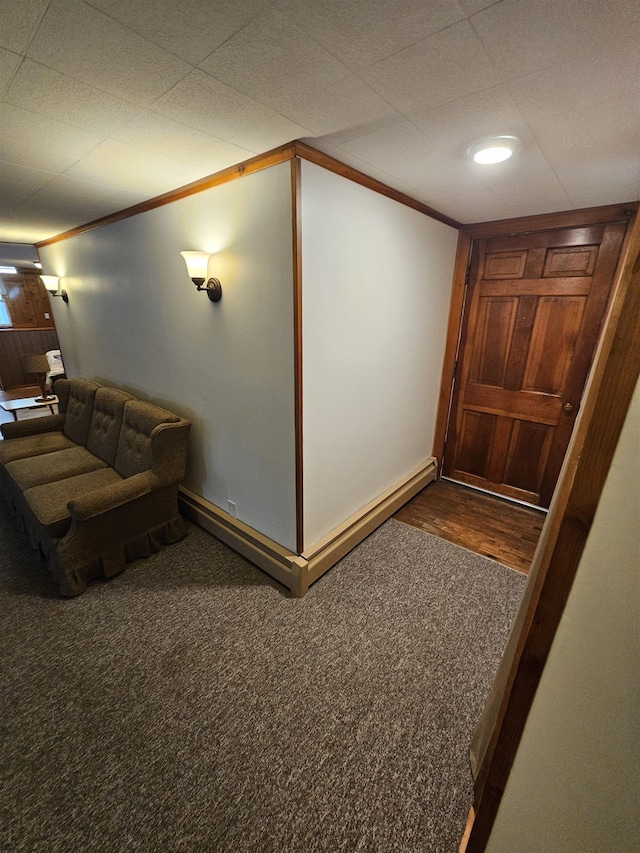 interior space featuring baseboards, crown molding, and carpet flooring