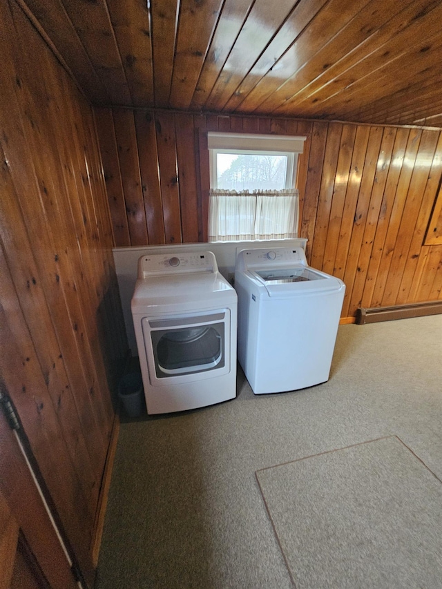laundry area with carpet flooring, washer and clothes dryer, wood walls, wooden ceiling, and laundry area