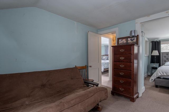 sitting room featuring light colored carpet and lofted ceiling