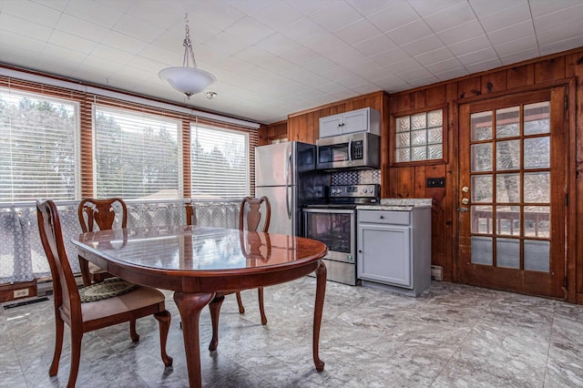 dining room with wooden walls
