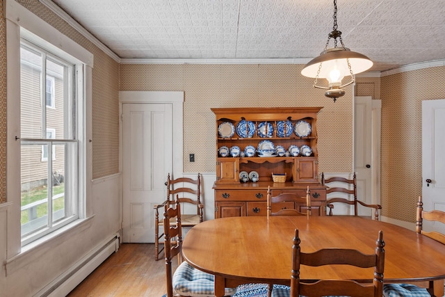 10 Crescent St, Wilton, NH 03086 - dining room with a baseboard heating unit, crown molding, light wood-style floors, and wallpapered walls