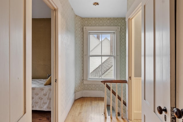 10 Crescent St, Wilton, NH 03086 - corridor featuring wallpapered walls, hardwood / wood-style floors, and an upstairs landing