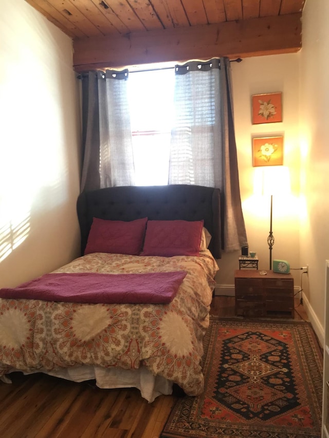 bedroom with wood ceiling, wood finished floors, and beamed ceiling