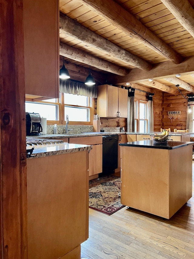 kitchen featuring a center island, a healthy amount of sunlight, black dishwasher, and light wood-style flooring