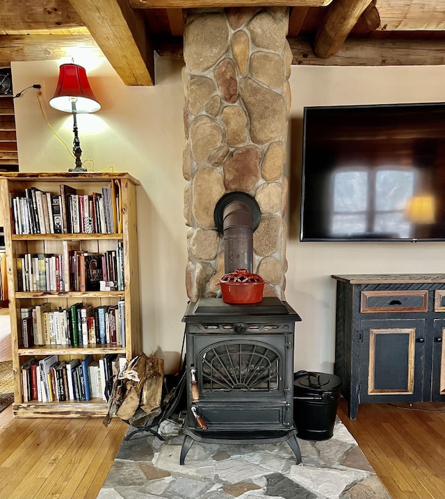 room details with wood finished floors and a wood stove