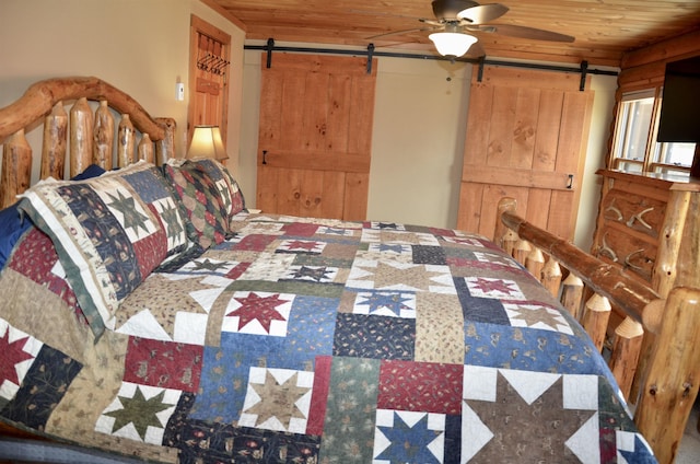 bedroom with wood ceiling and a barn door