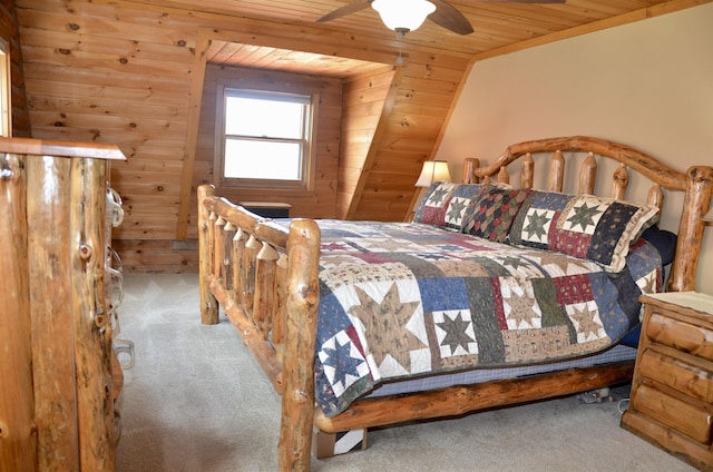 bedroom with wood ceiling, carpet flooring, wood walls, and ceiling fan