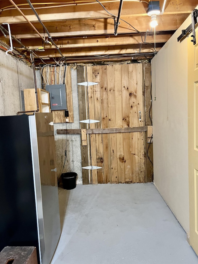 unfinished basement featuring freestanding refrigerator, electric panel, and wood walls