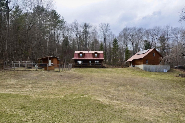 view of yard with an outdoor structure and fence
