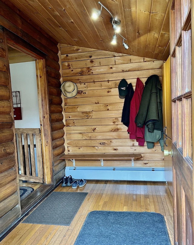 mudroom featuring wooden ceiling, rustic walls, lofted ceiling, and hardwood / wood-style floors
