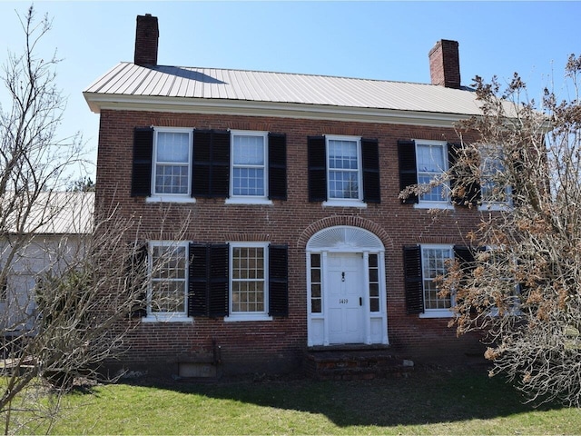 1419 Stonebridge Rd, Georgia, VT 05468 - colonial-style house with brick siding, entry steps, a chimney, and metal roof