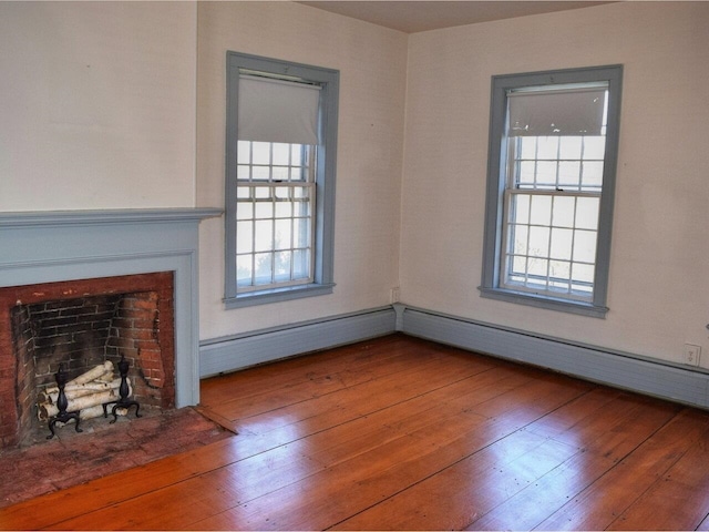 1419 Stonebridge Rd, Georgia, VT 05468 - unfurnished living room with a fireplace with flush hearth, a healthy amount of sunlight, and hardwood / wood-style flooring