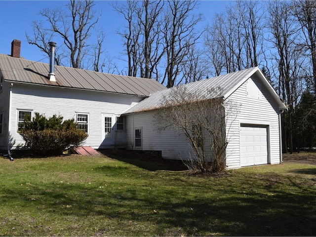 1419 Stonebridge Rd, Georgia, VT 05468 - view of side of home featuring a chimney, a yard, and metal roof