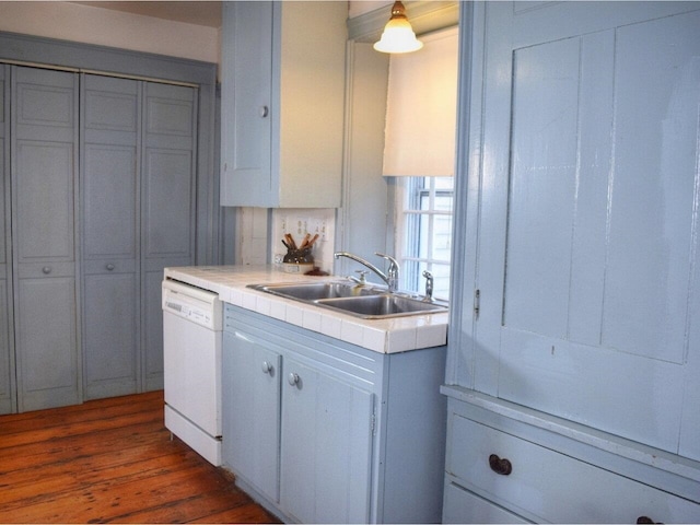 1419 Stonebridge Rd, Georgia, VT 05468 - kitchen with white dishwasher, a sink, tile counters, and dark wood finished floors