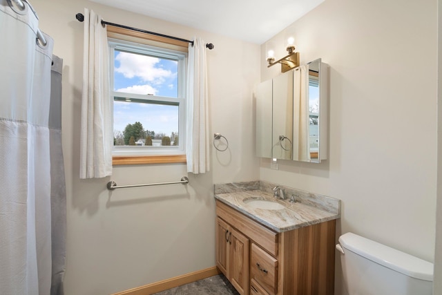 bathroom featuring toilet and vanity