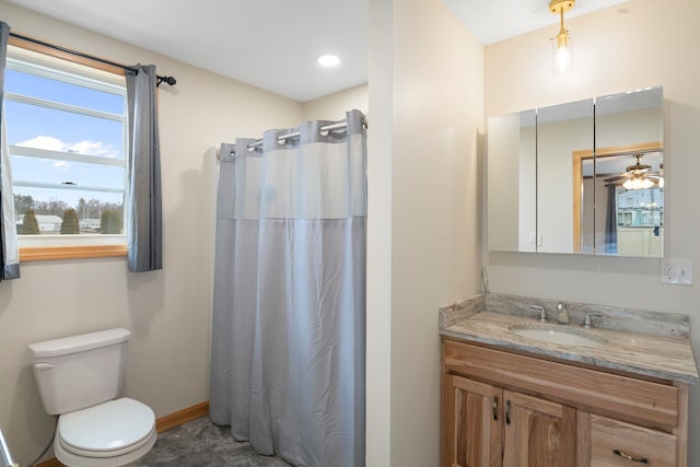 full bath featuring baseboards, curtained shower, vanity, and toilet